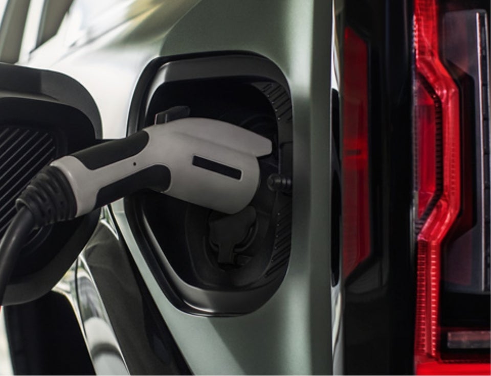 Close up of charging port with charger plugged in on a GMC Hummer EV SUV - Findlay GMC in Bullhead City AZ